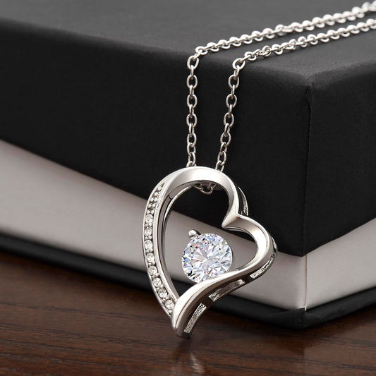 Silver Forever Love heart necklace close-up on two-tone gift box