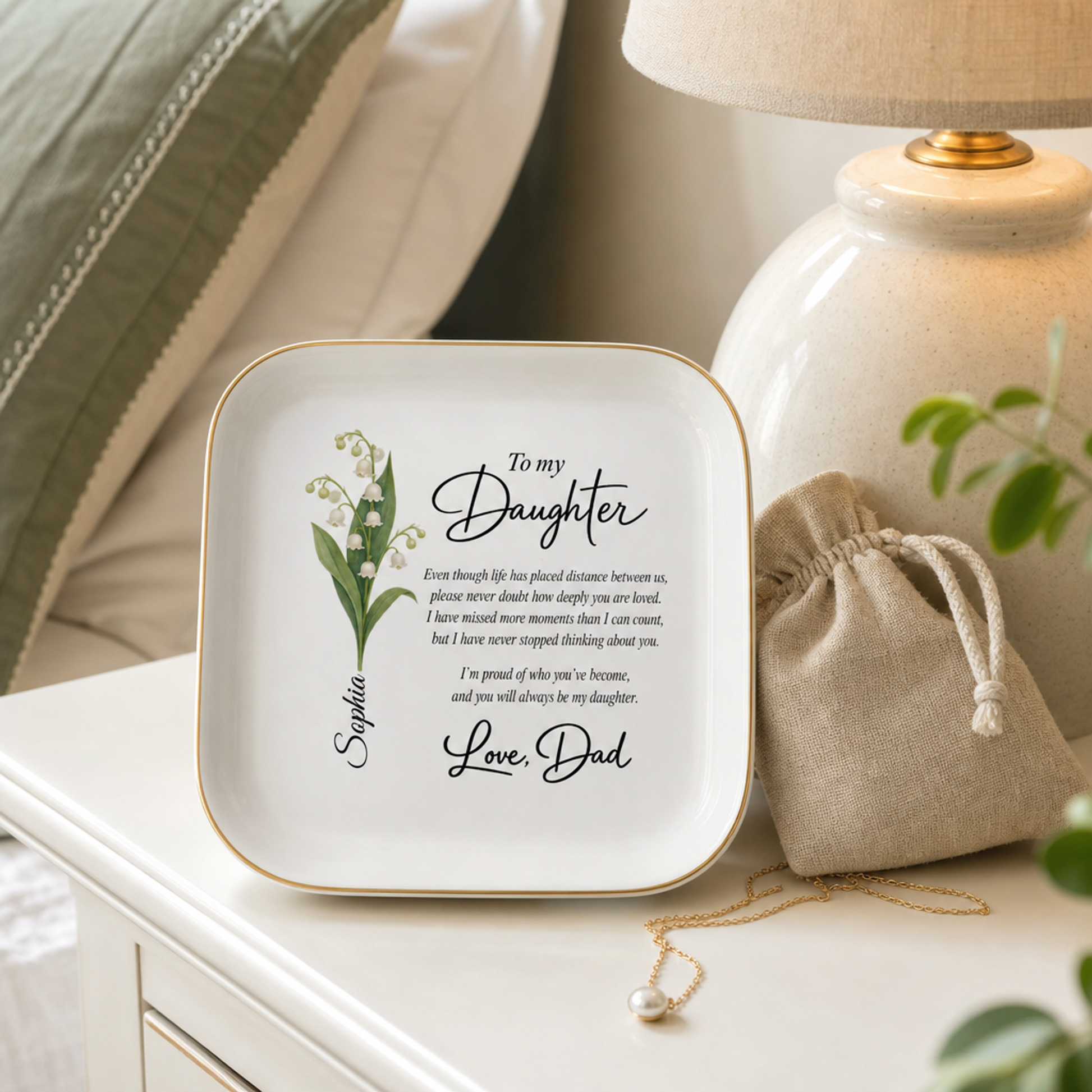 Jewelry dish displayed on a bedside nightstand with a linen pouch and necklace